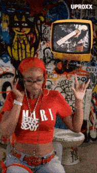 a woman wearing headphones and a red shirt that says m.r.i. big sexy