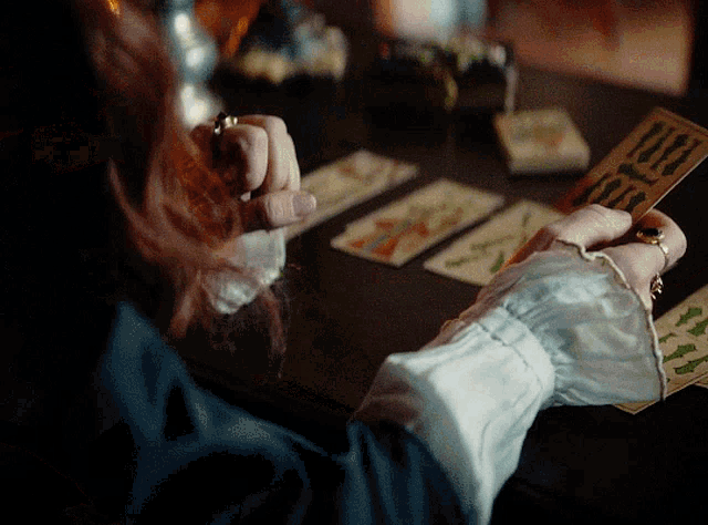 a woman is holding a tarot card that says ' i love you ' on it