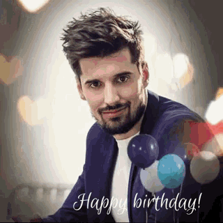 a man in a suit with balloons and the words happy birthday