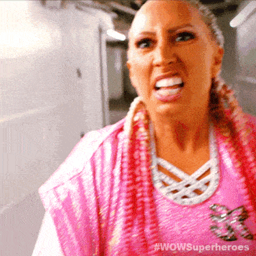 a woman in a pink shirt with the words wowsuperheroes on the bottom