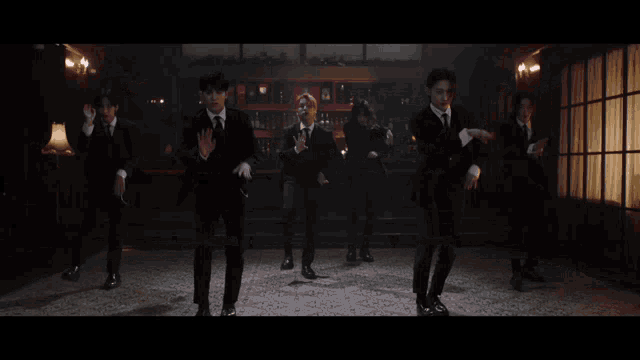 a group of men dancing in a dark room