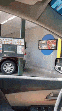a car is parked in front of a burger king drive through