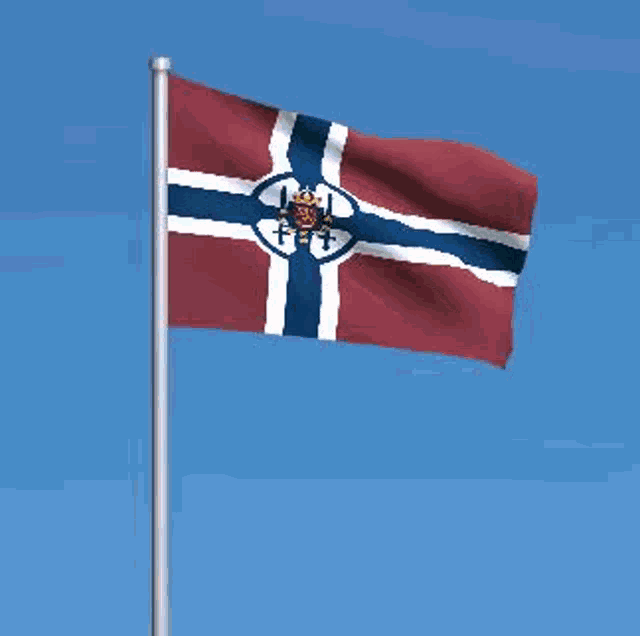 a red white and blue flag is waving in the wind against a blue sky