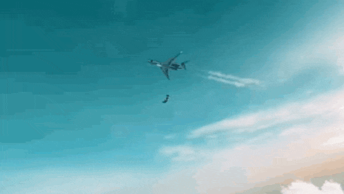 a plane is flying through a blue sky with a drone flying in the distance .