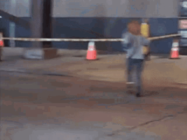 a woman is walking down a street with a fire hydrant in the background