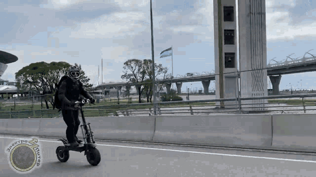 a person is riding a scooter on a highway with a sticker that says ' scooters ' on it