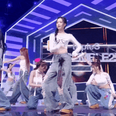 a group of women are dancing on a stage in front of a sign that says types e2