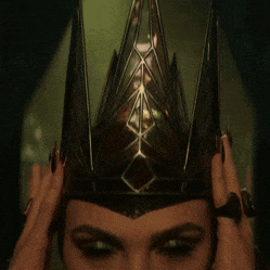 a woman wearing a crown with a diamond design on it