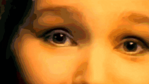 a close up of a woman 's eyes with a dark background