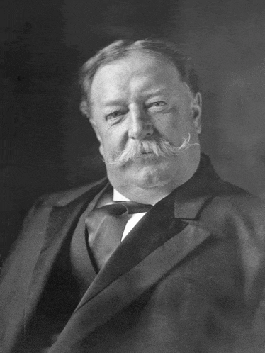 a man with a mustache and a suit and tie