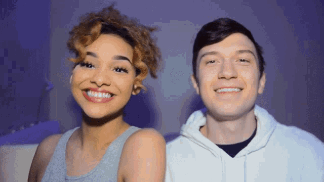 a man and a woman smile for the camera