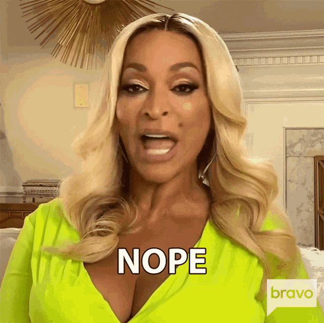 a woman wearing a neon yellow top says nope