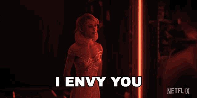 a woman in a red dress says " i envy you " in a netflix ad
