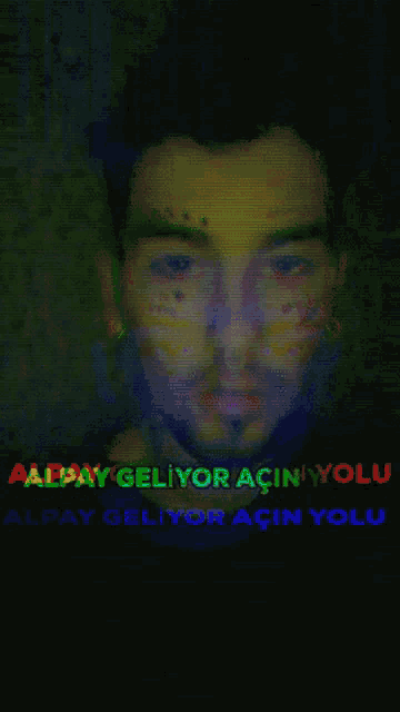 a man with a tattoo on his face has the word alpay on the bottom of his face