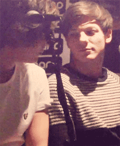 a man in a striped shirt looks at another man