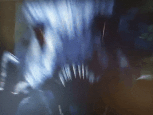 a close up of a monster 's mouth with sharp teeth in the dark