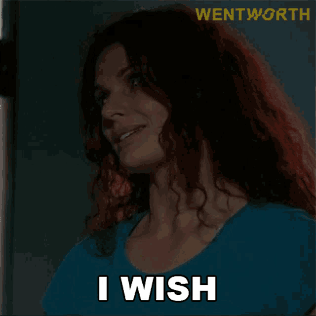 a woman with red hair says i wish in a blue shirt