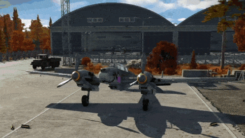 a plane is parked in front of a hangar that says ' a ' on the side