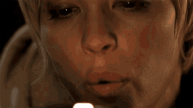 a close up of a woman lighting a candle in her mouth