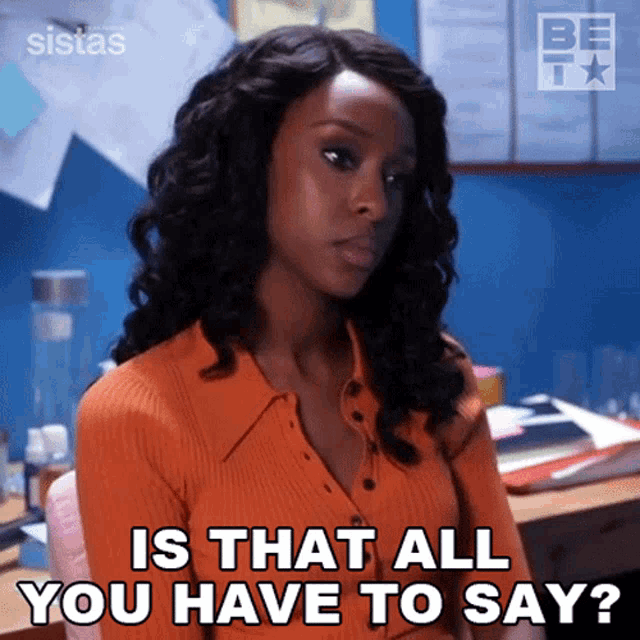 a woman sitting at a desk with the words is that all you have to say