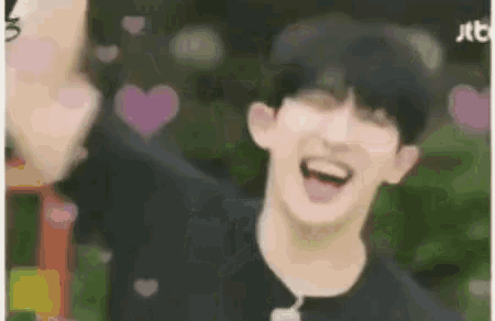 a close up of a person 's face with hearts flying around him .