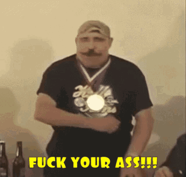 a man with a medal around his neck says " fuck your ass !!! "