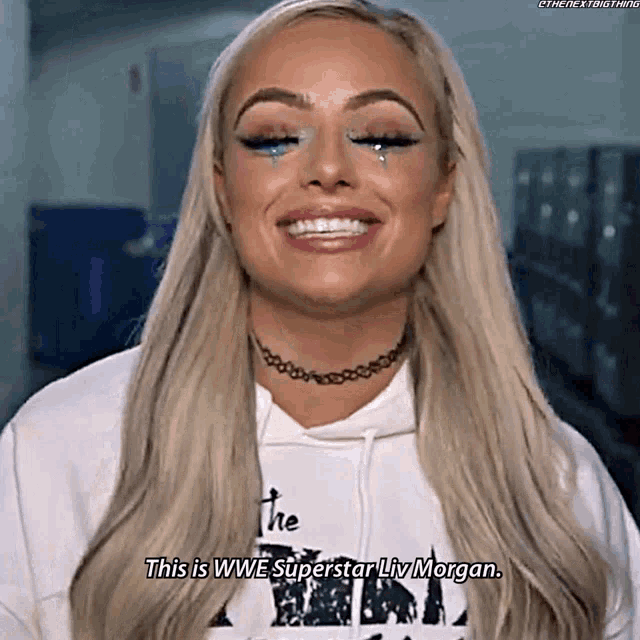 a woman with tears in her eyes is smiling and saying this is wwe superstar liv morgan