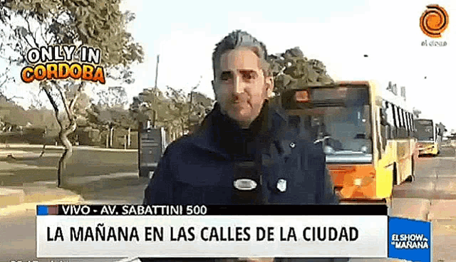 a man stands in front of a sign that says la mañana en las calles de la ciudad