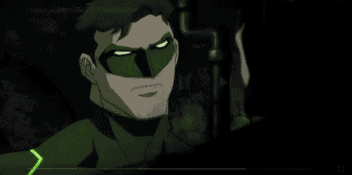 batman and green lantern are standing next to each other in a dark room . green lantern is glowing in the dark .