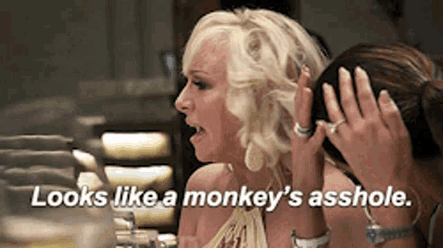 a woman says " looks like a monkey 's asshole " while sitting at a table