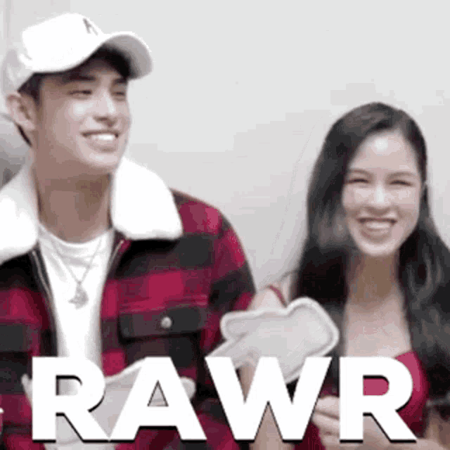 a man and a woman are standing next to each other with the word rawr written on the bottom
