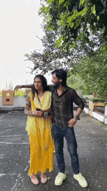 a man and woman are standing next to each other in a parking lot