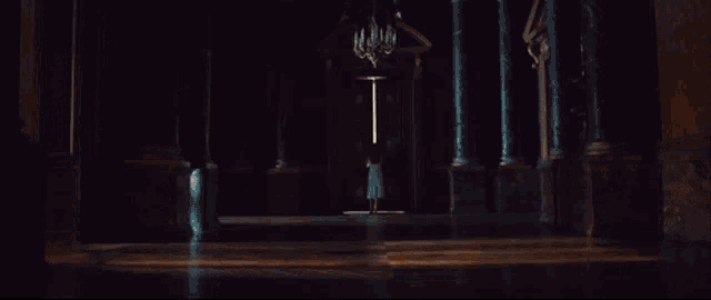 a woman in a white dress is walking through an open door