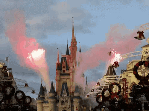 fireworks are displayed in front of the cinderella castle and the broadway theater