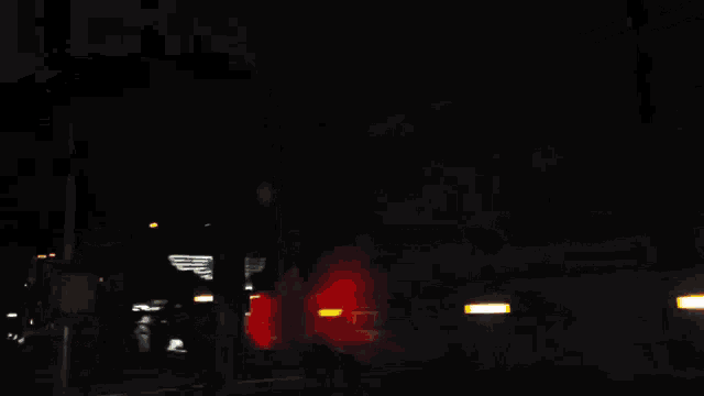a blurry picture of a train with an american flag on the side of it