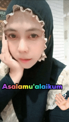a woman wearing a hijab with the words asalamu ' alaikum written on the bottom