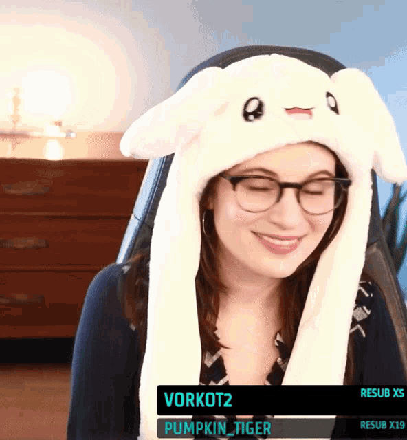 a woman wearing glasses and a white bunny hat with the name vorkot2 on the screen
