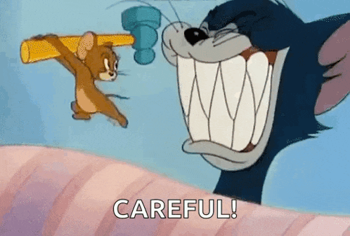 a cartoon of tom and jerry fighting with a hammer and the words `` careful ! ''
