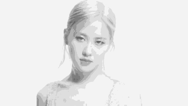 a black and white photo of a woman with blonde hair and a sequined dress .