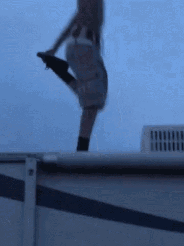 a blurry picture of a person jumping off a roof