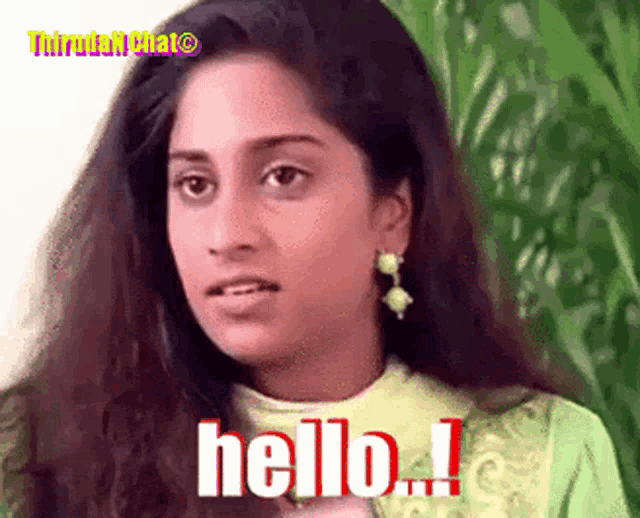 a woman says hello in a green shirt