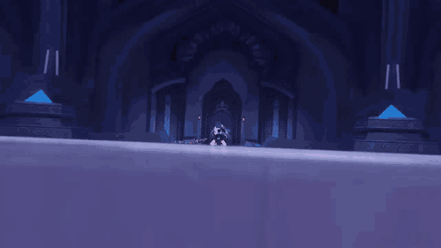 a dark room with a blue archway and a few columns