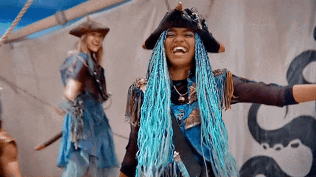 a girl with blue braids is wearing a pirate hat and dancing on a boat .