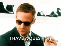 a man wearing sunglasses is holding a pen and says `` i have a question '' .