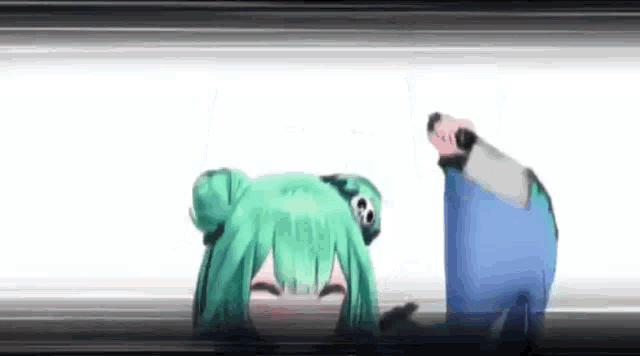 a green haired anime girl is laying on the floor .