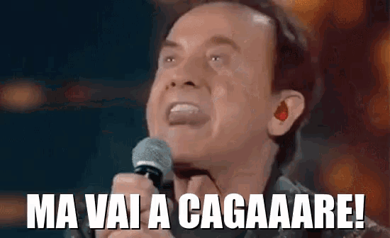 a man is singing into a microphone with the words ma vai a cagaaare !