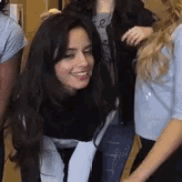 a group of women are standing next to each other and holding hands .