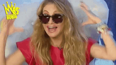 a woman wearing sunglasses and a red shirt is making a funny face ..