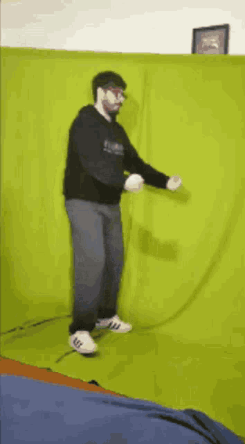a man standing in front of a green screen