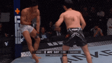 two men are fighting in a boxing ring with the ufc scoreboard displaying 0:07